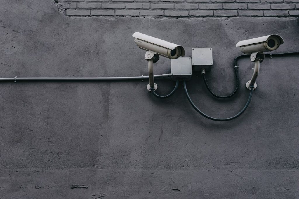 Two outdoor surveillance cameras mounted on a wall.