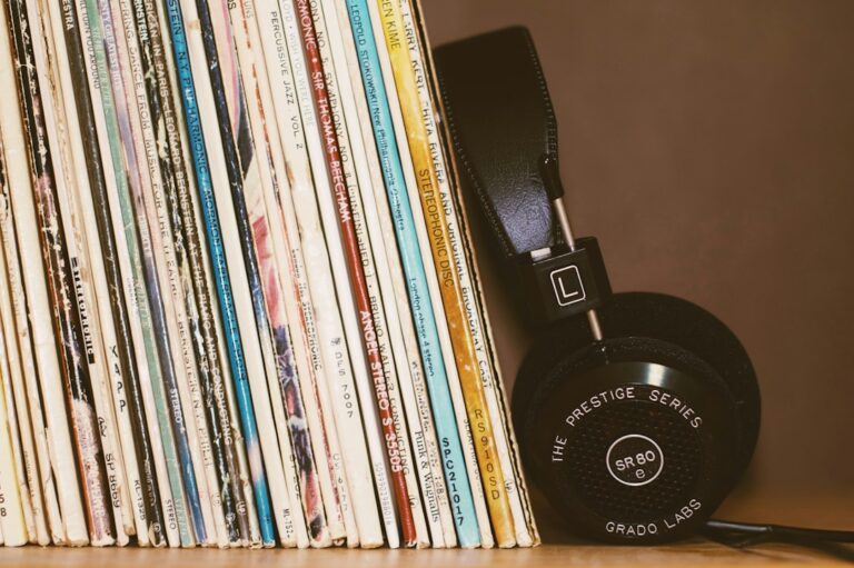 Headphones resting beside a row of vinyl records.