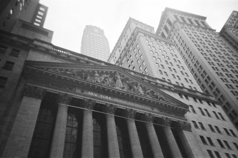 Black-and-white photograph of the New York Stock Exchange exterior.