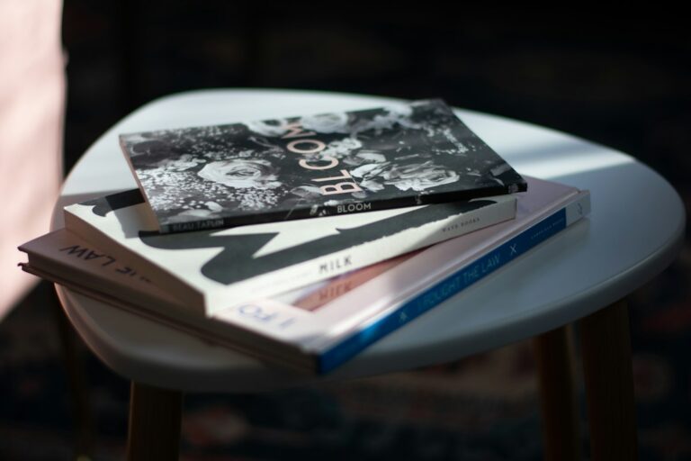 A small stack of books on a round table in sunlight