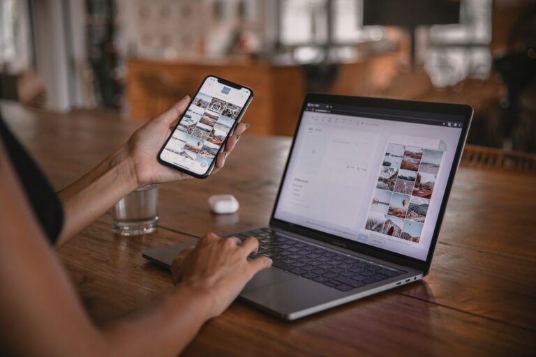 A person reviewing a social media photo grid on a phone and laptop.