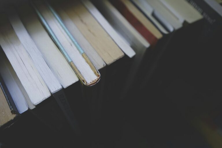 A row of books seen from above, showing their page edges.