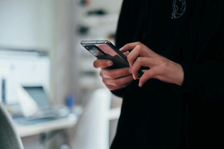 A person holding and using a smartphone; an illustrative photograph.