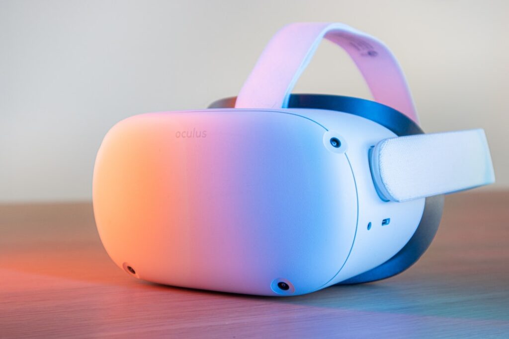 A white Oculus virtual reality headset resting on a tabletop.