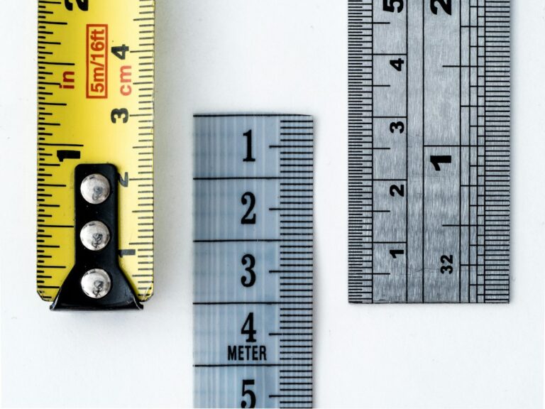 Measuring tapes and a metal ruler with metric and imperial markings.
