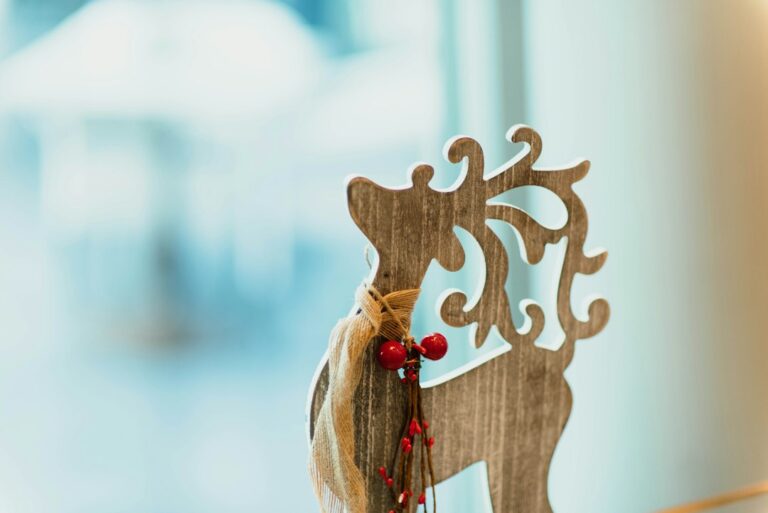 Wooden reindeer decoration with red berries and twine