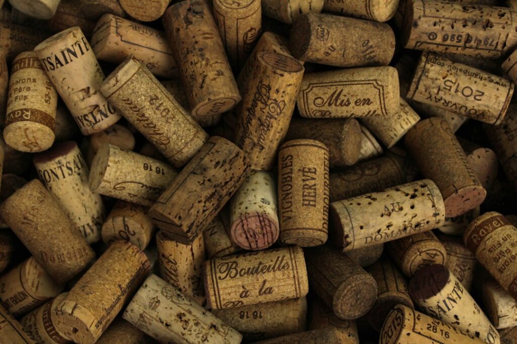 A pile of used wine corks with printed markings