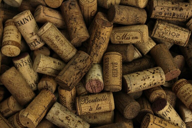 A pile of used wine corks with printed markings