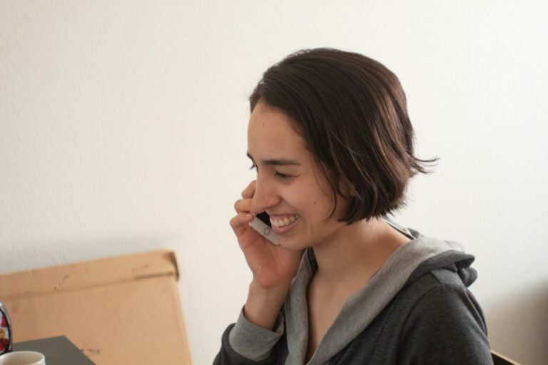 A woman making a phone call indoors.