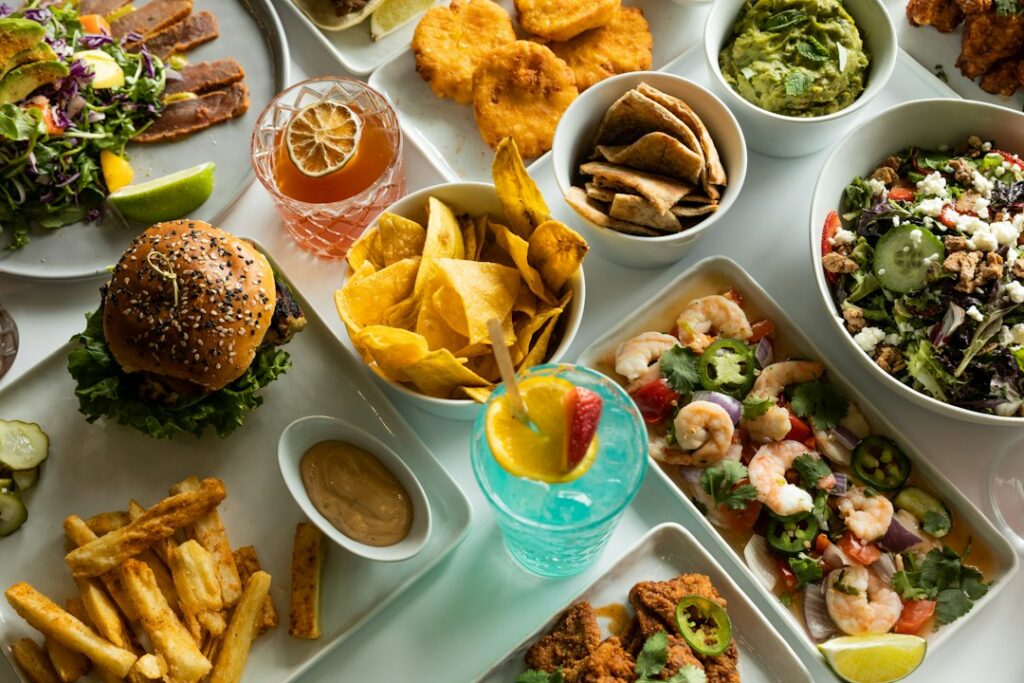 Restaurant dishes and drinks arranged across a table.