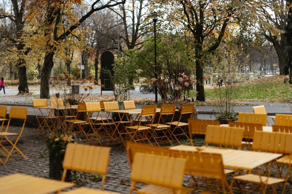Yellow cafe tables and chairs in an outdoor seating area
