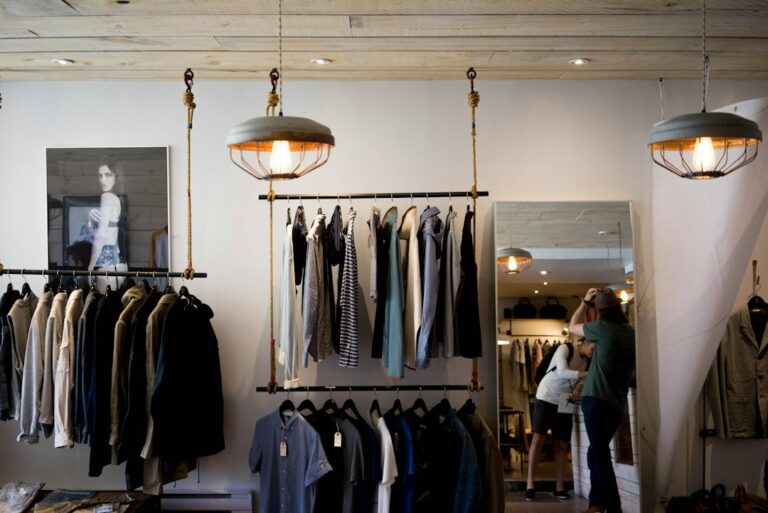 Clothing racks and a mirror inside a boutique