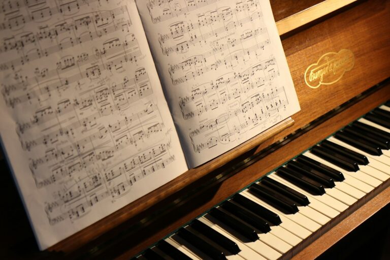 Open sheet music on a wooden piano above the keyboard