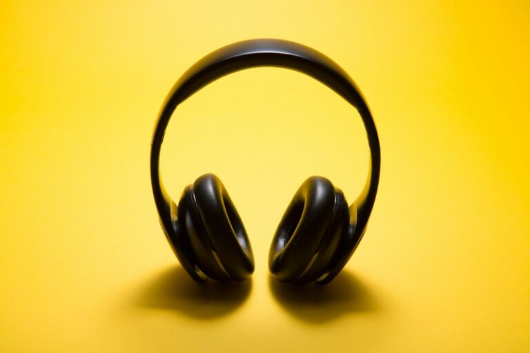 Black over-ear headphones against a yellow background