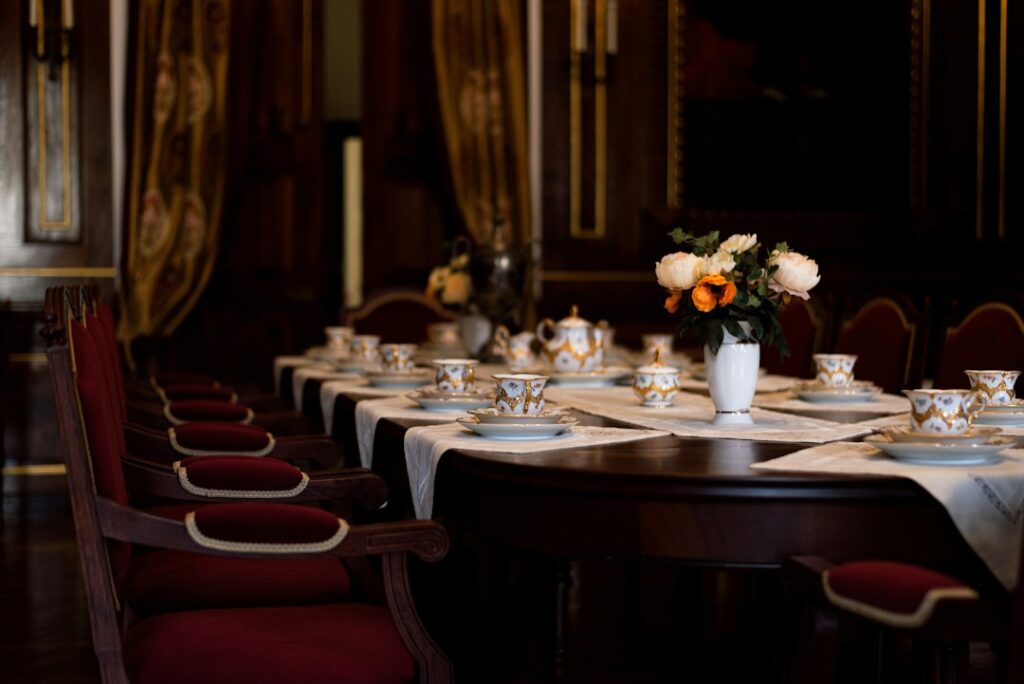 Dining table set with cups, plates and a vase of flowers