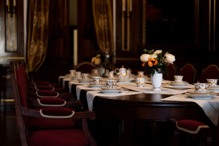 Dining table set with cups, plates and a vase of flowers