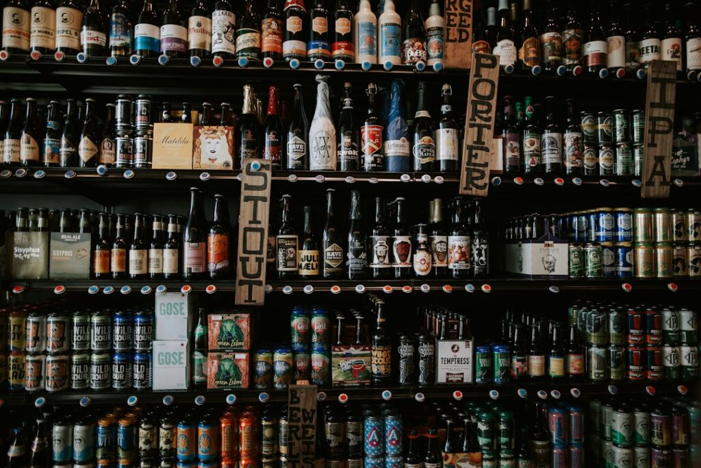 Rows of beer bottles and cans with varied labels on shelves