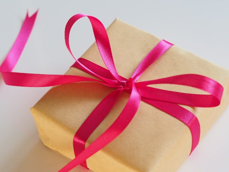 A brown-paper gift tied with a bright pink ribbon.
