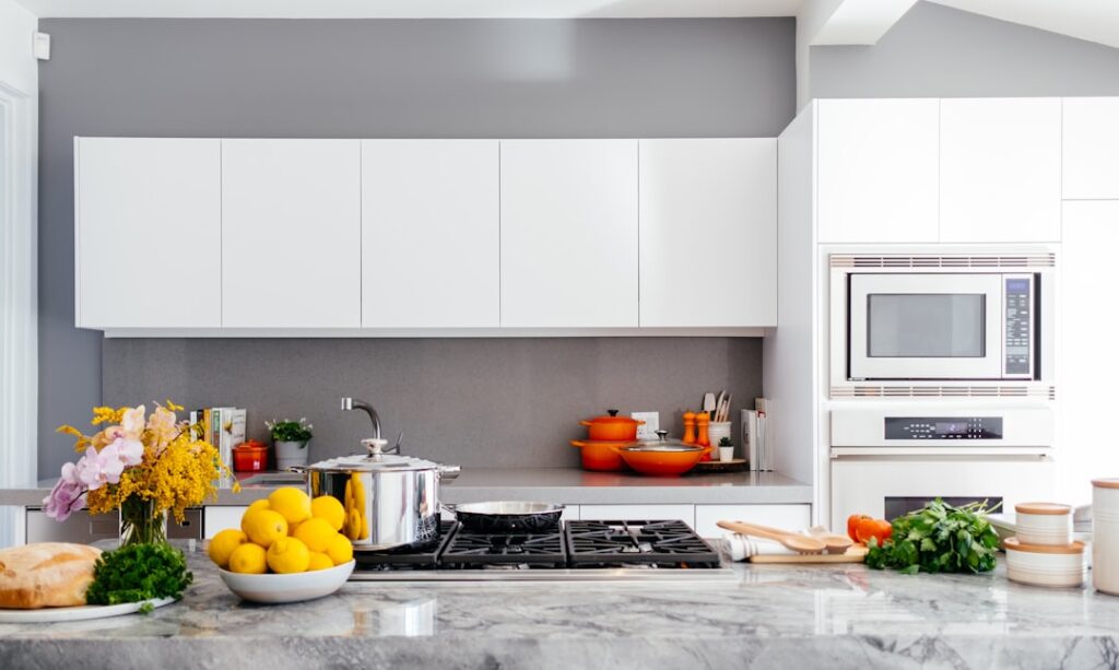 Kitchen with a stove, microwave, oven, and cookware
