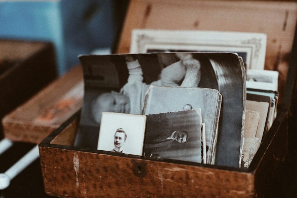 Old portrait photographs arranged in an open wooden box