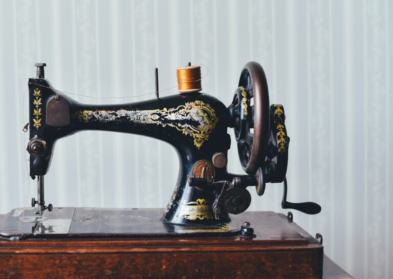 Vintage black and gold sewing machine on a wooden base