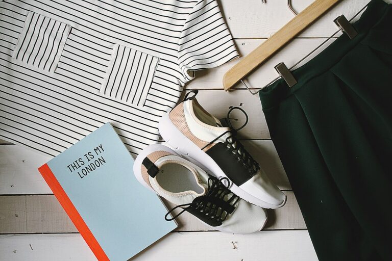 Striped top, green skirt and trainers arranged beside a book