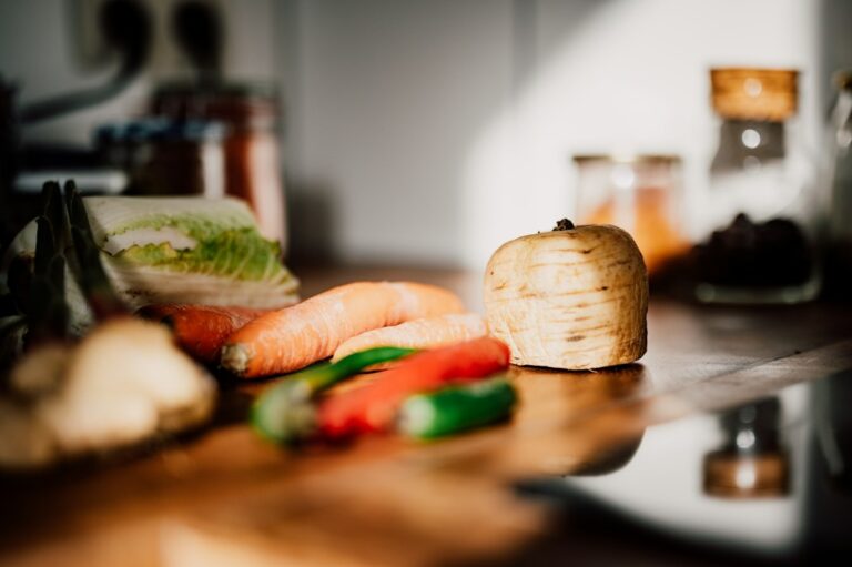 Carrots, peppers and other vegetables arranged on a kitchen work surface