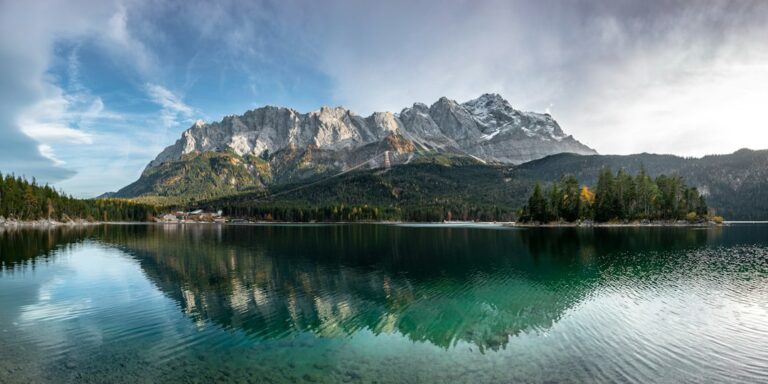 Rocky mountains and forest reflected in a clear lake