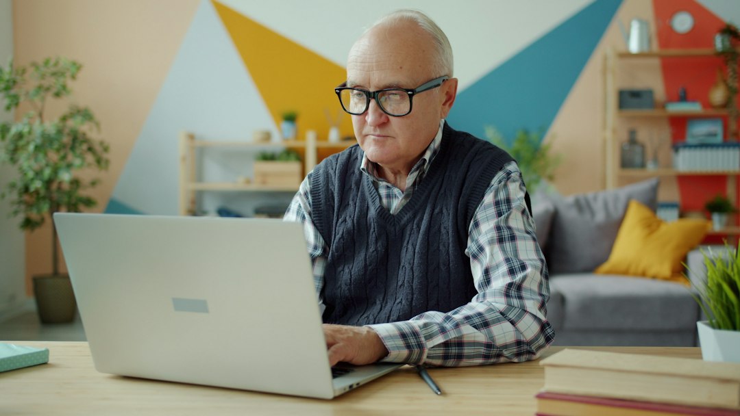 Older adult learning with a laptop at home.
