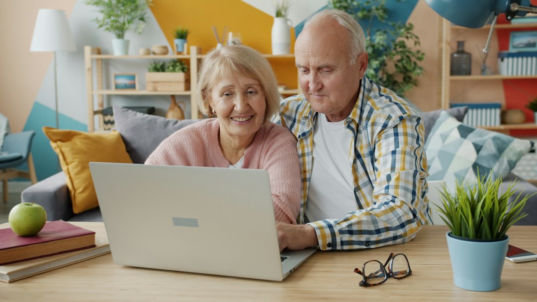 Older couple using a laptop together at home.